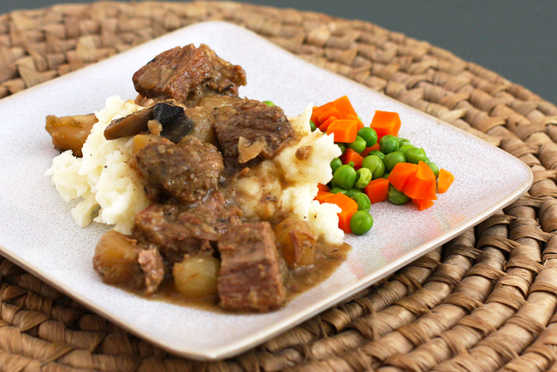Slow cooker beef and beer stew on mashed potatoes.