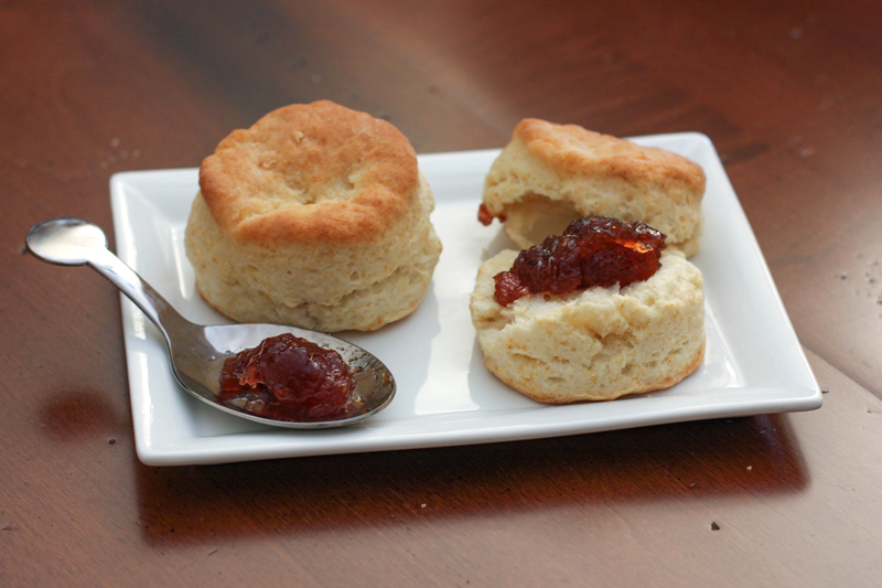 Buttermilk biscuits on a plate with jam.