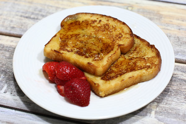Plate of French toast with strawberries.
