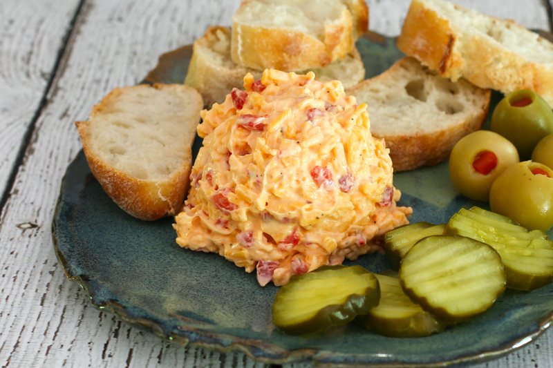Pimiento cheese spread with olives and bread.