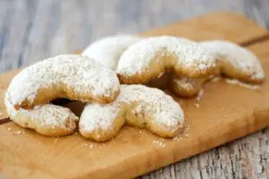 almond crescent cookies on a board