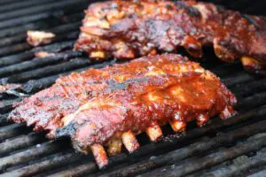 ribs on the grill with maple apple barbecue sauce