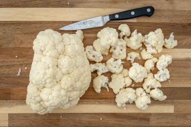 Cutting cauliflower florets for air fryer roasted cauliflower.