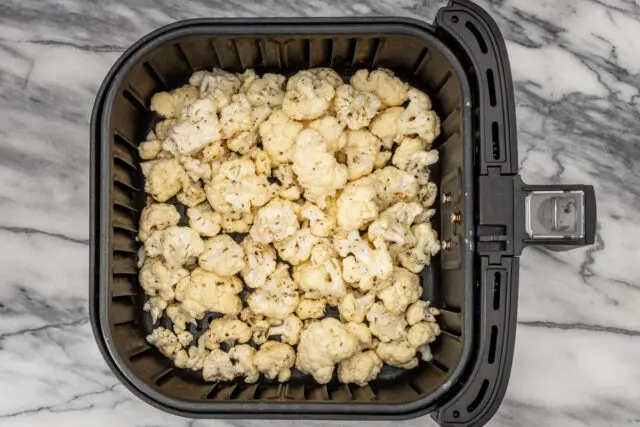 Seasoned cauliflower in the air fryer for roasted cauliflower side dish.