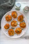 A plate of homemade air fryer potato croquettes made with leftover mashed potatoes, cheese, and herbs.