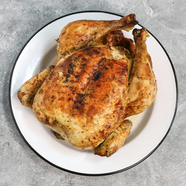 Air fryer roasted chicken on a plate.