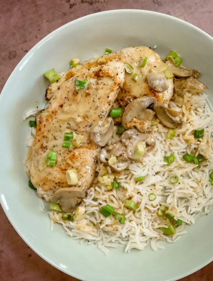 apple brandy chicken on a bed of rice with mushrooms and green onions