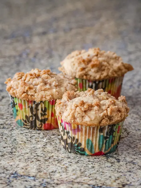 three apple crumble muffins