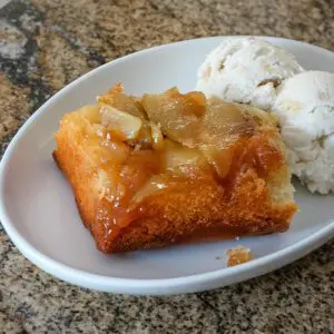 apple upside-down cake on a dessert place with ice cream