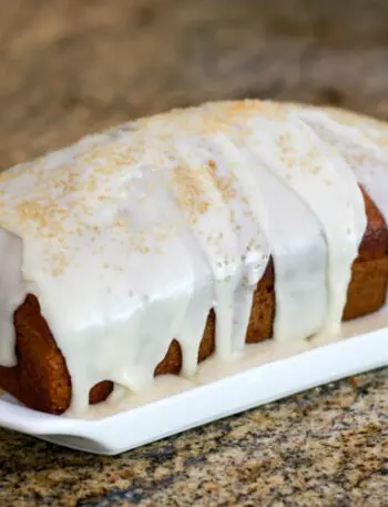 applesauce cake glazed and garnished with demerara sugar.