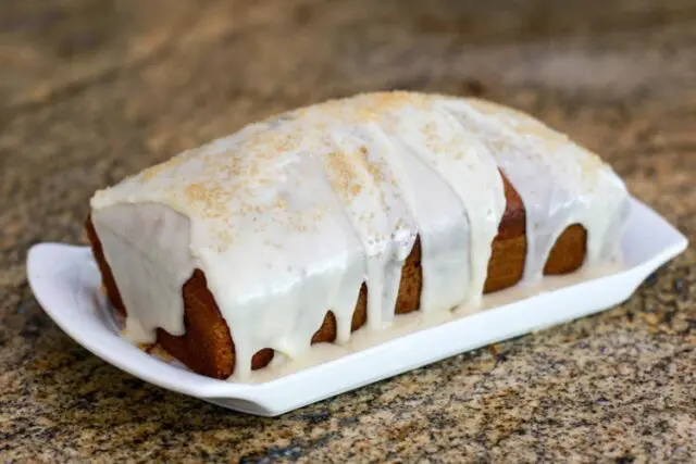 applesauce cake glazed and garnished with demerara sugar.