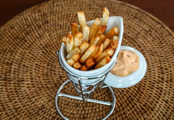 baked fries in a porcelain french fry cup