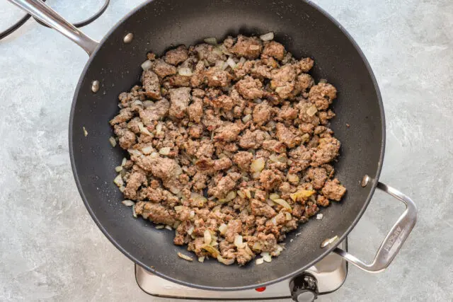 Cooking the ground beef and onions for a big meal of baked ziti.