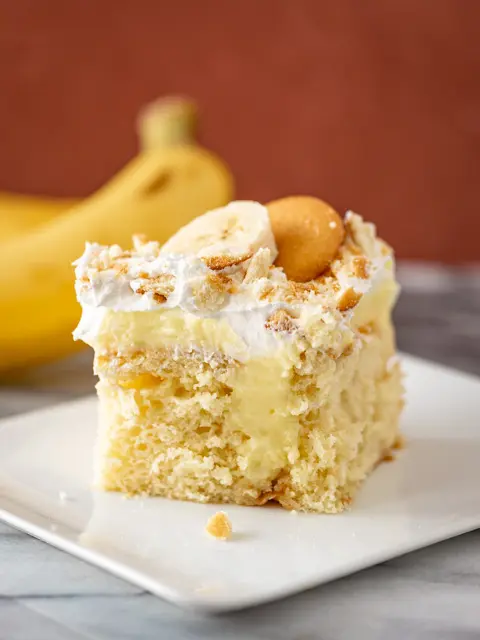 a slice of banana poke cake