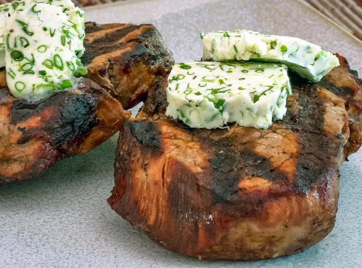 herb butter on grilled beef steaks