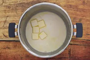 adding the butter and milk to the potatoes