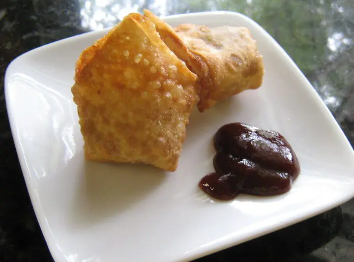 chicken wonton appetizers on a plate with barbecue sauce