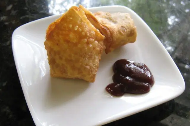 chicken wonton appetizers on a plate with barbecue sauce