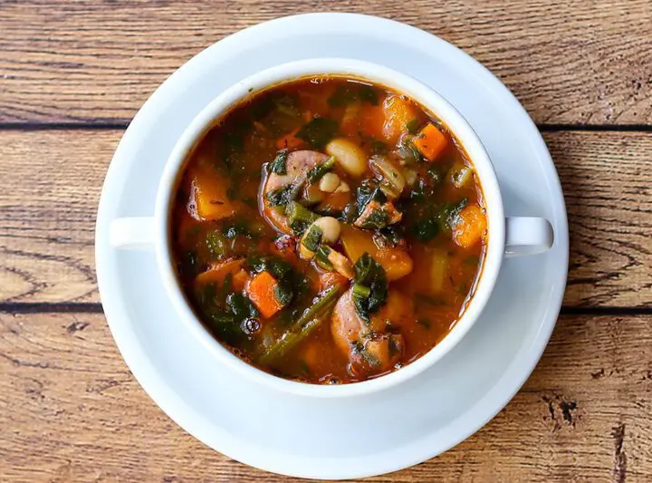 beans and sausage soup with carrots, ham, tomatoes.