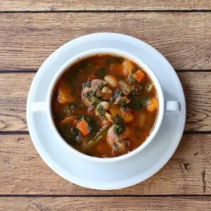 bean and sausage soup in a bowl