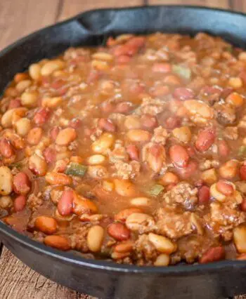 cookout beans with beef in a large iron skillet