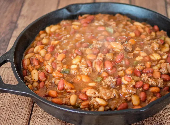 cookout beans with beef in a large iron skillet