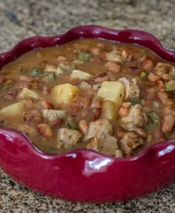 slow cooker pineapple beans with sausage in a serving dish