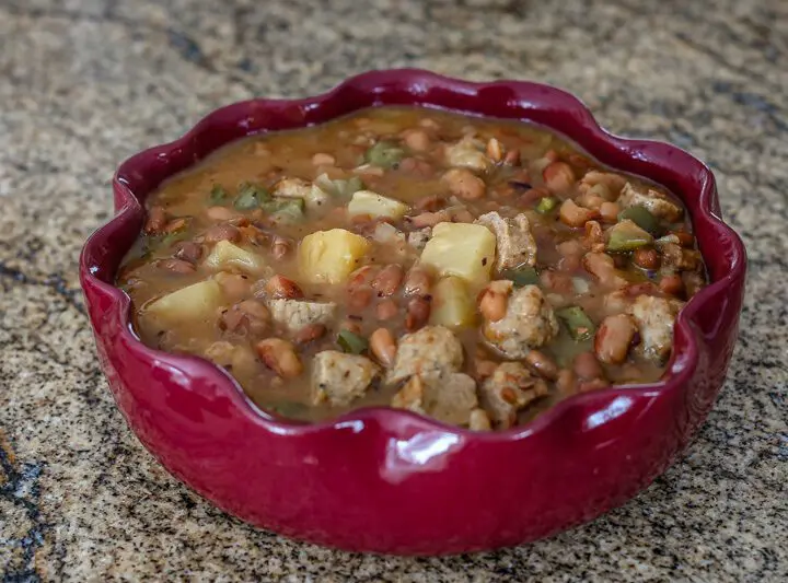 slow cooker pineapple beans with sausage in a serving dish