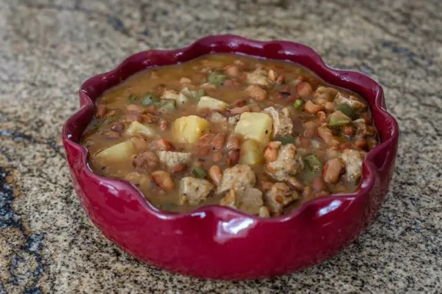 slow cooker pineapple beans with sausage in a serving dish