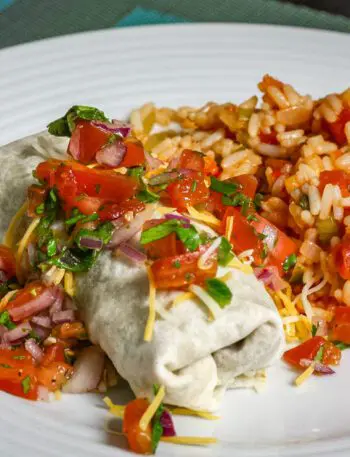 beef and bean burritos on a plate with mexican rice and salsa