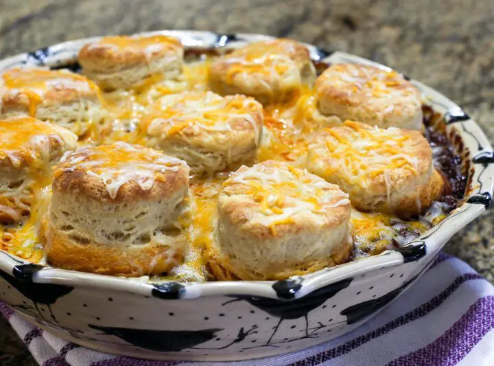 beef and bean casserole with biscuits and cheese topping