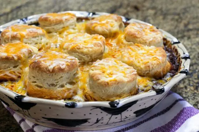 beef and bean casserole with biscuits and cheese topping