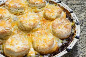 beef and bean casserole with biscuit and cheese topping