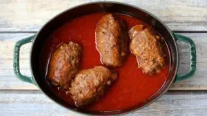 beef rolls, rouladen, and tomato sauce in a dutch oven