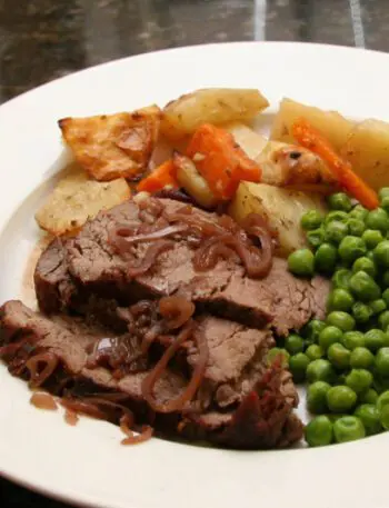 sliced beef tenderloin roast with carrots, potatoes, and onions