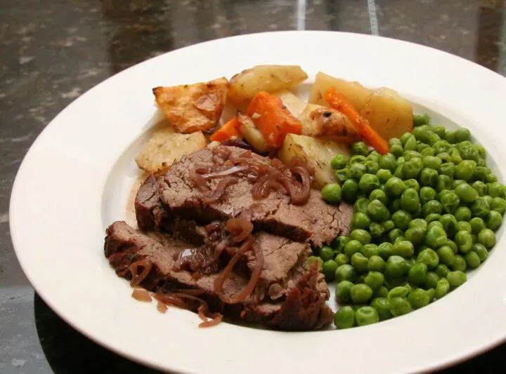 sliced beef tenderloin roast with carrots, potatoes, and onions