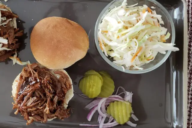 Beer braised pork shoulder, shredded and placed on a sandwich bun