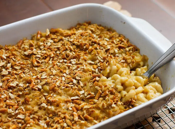 beer macaroni and cheese with a pretzel topping, in a baking dish