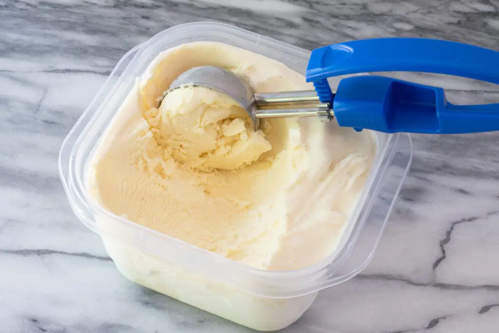 scooping gelato from a container