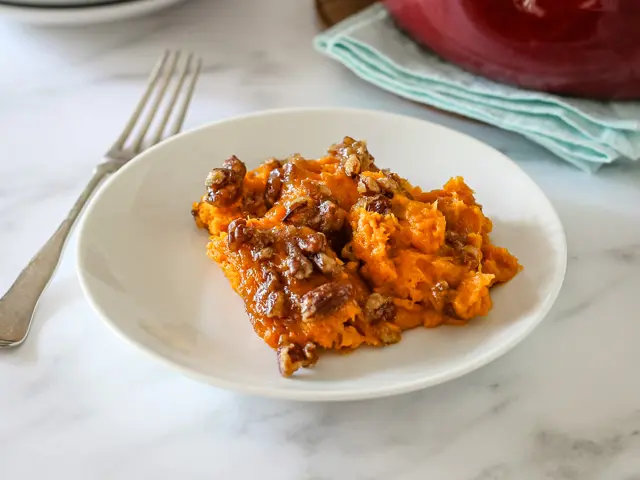 A serving of sweet potato casserole on a plate.