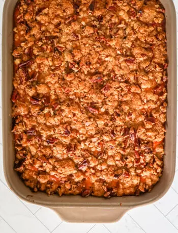 A baked sweet potato casserole with pecan topping.