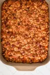 Baked sweet potato casserole in a baking dish with pecan streusel topping.