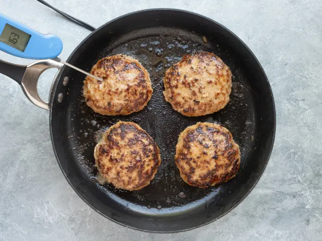 Turkey burgers in the skillet perfectly cooked.