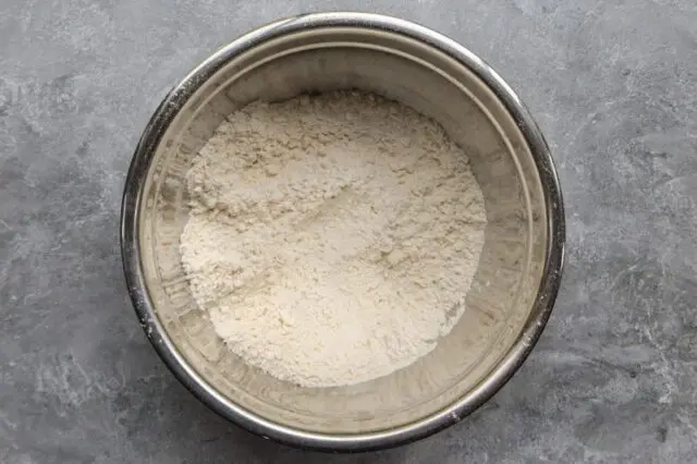 the flour and butter mixture are in a bowl to be mixed with the buttermilk.