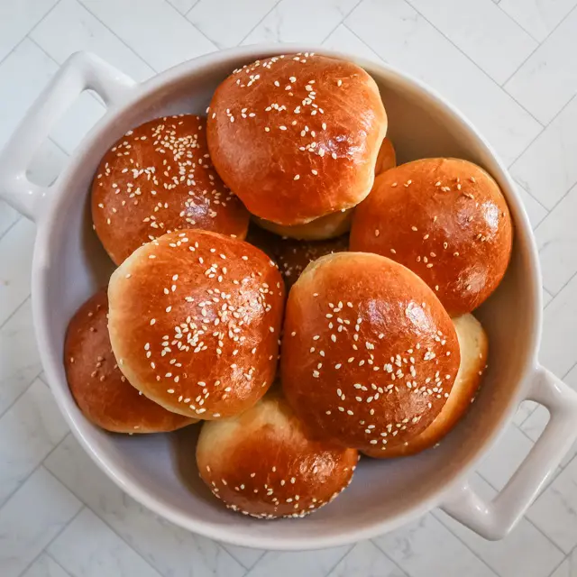 homemade brioche buns in a large bowl