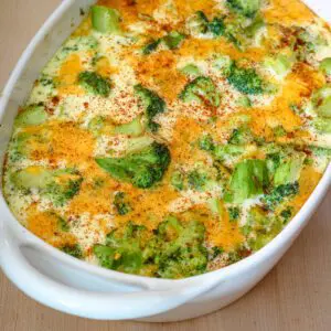 broccoli custard casserole with cheese in a baking dish