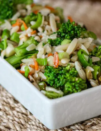 broccoli salad with orzo and wine vinaigrette, in a serving dish.