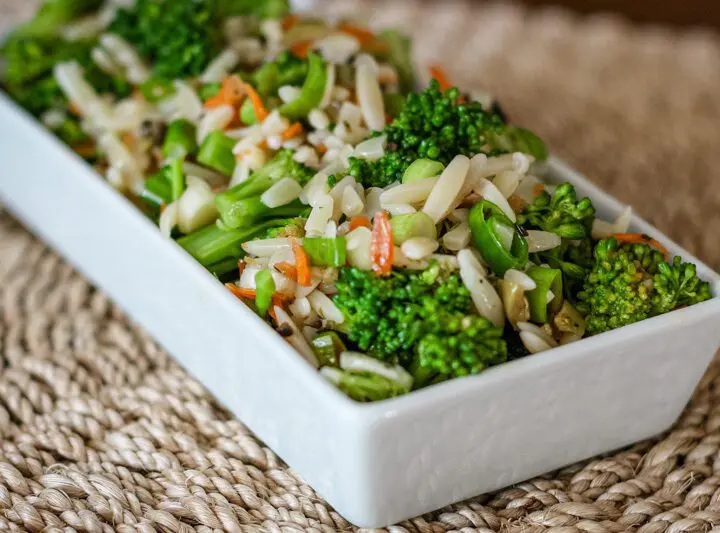 broccoli salad with orzo and wine vinaigrette, in a serving dish.