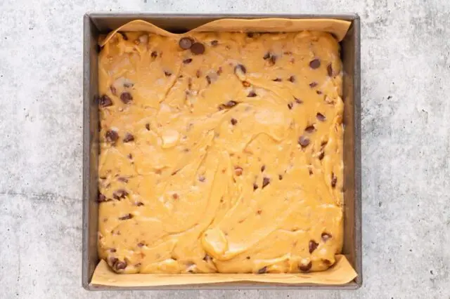 Brown butter blondie dough/batter in the pan ready to bake.