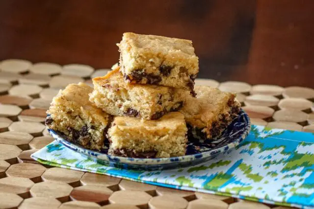 brown sugar bars with chocolate chips, stacked on a plate.